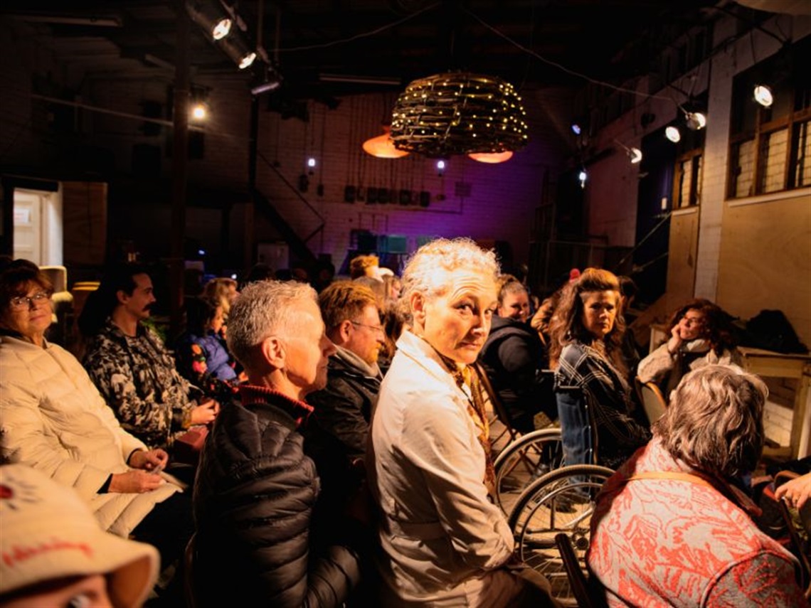 A group of people sitting in chairs, waiting. For what? Noone is quite sure.